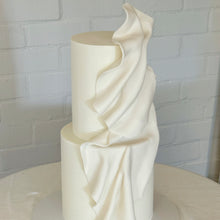 Load image into Gallery viewer, Sculptural two tier white wedding cake with draping