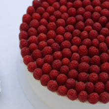 Load image into Gallery viewer, Cake decorated with red berries on a white background