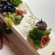 Load image into Gallery viewer, Close-up of a dessert with fruits and greenery on a white surface