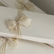 Load image into Gallery viewer, White slice boxes with decorative bows on a white surface