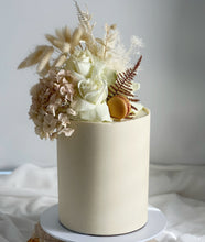 Load image into Gallery viewer, Boho Dreaming double height cake finished with smooth white chocolate ganache and neutral dried florals