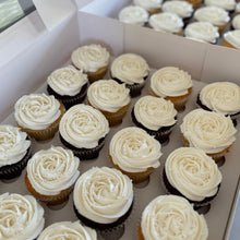 Load image into Gallery viewer, Box of cupcakes with white frosting arranged in a grid pattern.