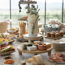 Load image into Gallery viewer, Triple stack ethereal cake with fresh florals displayed as the centrepiece on a styled dessert table at an elegant event