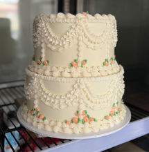 Load image into Gallery viewer, Elegant vintage round tiered cake with traditional piped borders and detailing and flowers