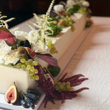 Load image into Gallery viewer, long table cake with flowers and fruits made by spodeli and on display at a wedding at ravella