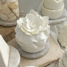 Load image into Gallery viewer, White sculpted floral mini cake with magnolia-style petals, part of Spodeli Mini Series, displayed on a round marble base