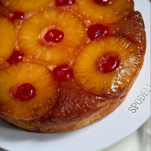 Load image into Gallery viewer, Close-up of caramelised pineapple rings and cherries on upside down pineapple cake