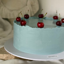 Load image into Gallery viewer, Side view of The European Cherry Edit showing smooth, lightly textured blue ganache finish by Spodeli