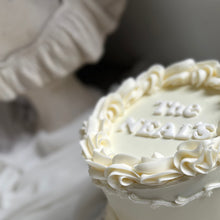Load image into Gallery viewer, Round vintage wedding cake with white pearl finish and classic piped design