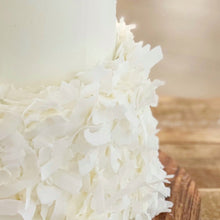 Load image into Gallery viewer, Close-up of hand-applied coconut flake texture on a tiered cake
