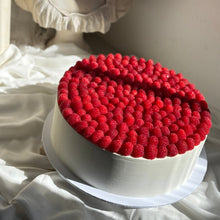 Load image into Gallery viewer, White cake with red berry topping on a white surface
