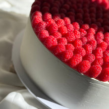 Load image into Gallery viewer, Close-up of a cake with red berries on a white surface
