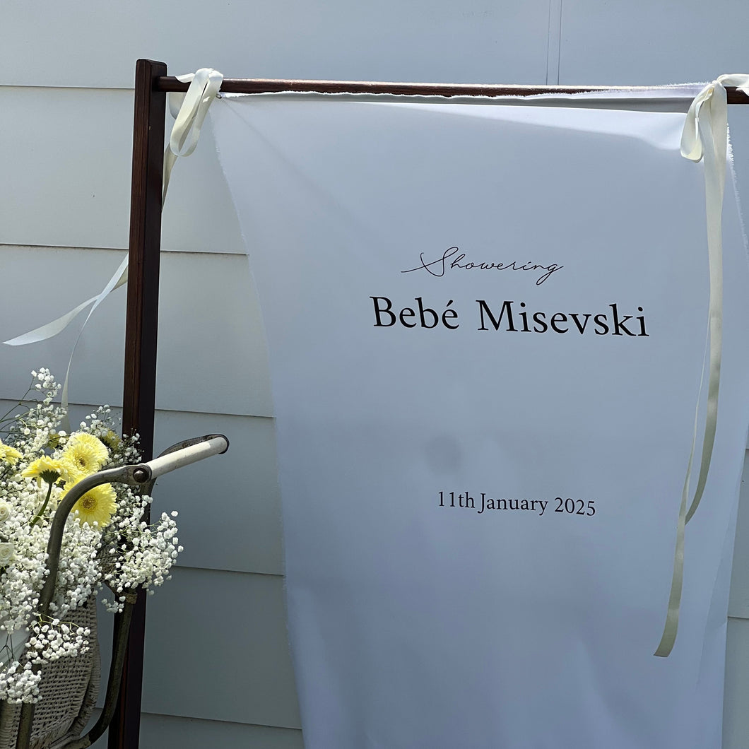 White banner with text on a stand outdoors
