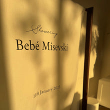 Load image into Gallery viewer, Fabric backdrop with text &#39;Bebé Misevski&#39; and date &#39;11th January 2023&#39; in a room.
