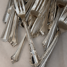 Load image into Gallery viewer, Close-up of silver vintage cake forks with intricate designs for spodeli cake tasting box experience
