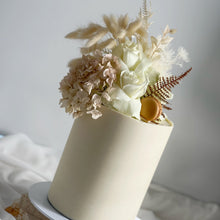 Load image into Gallery viewer, Detail of a double height ganache cake styled with soft neutral dried florals
