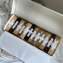 Load image into Gallery viewer, Cake tasting box with twelve coffee-sized cake slices arranged in a gift box
