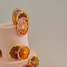Load image into Gallery viewer, Three-tier cake in warm European summer tones with dried citrus detailing
