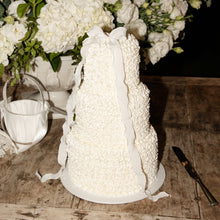 Load image into Gallery viewer, Three-tier bow cake with soft buttercream texture and sculptural finish
