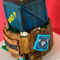 Angled view of a custom Fortnite supply drop cake showing sculpted crate detailing and hand-modelled elements by Spodeli 