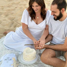 Load image into Gallery viewer, Couple celebrating with a heart shaped gender reveal cake during an intimate reveal
