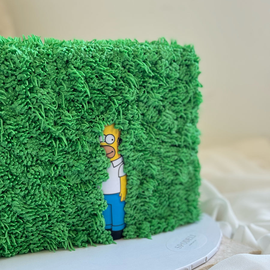 Custom Homer Simpson hedge meme cake with textured green buttercream