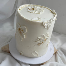 Load image into Gallery viewer, White palette knife floral cake with textured buttercream finish
