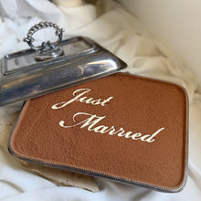 Load image into Gallery viewer, Top view of grand tiramisu dessert cake with cocoa finish saying just married
