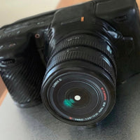 Sculpted camera cake with realistic lens and detailed body finish