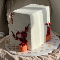 Side view of a Mediterranean house cake with sculpted shutters and climbing bougainvillea