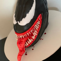 Angled view of a sculpted Venom cake by Spodeli highlighting character form and detailing