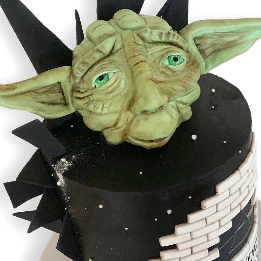 Close-up of hand-sculpted Yoda cake topper with detailed facial features