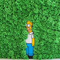 Green hedge buttercream cake with Homer Simpson figure