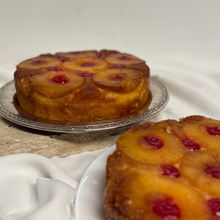 Load image into Gallery viewer, Styled upside down pineapple cake with golden caramelised fruit on vintage serving plates
