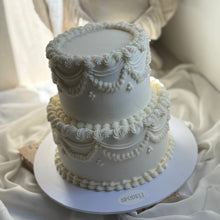 Load image into Gallery viewer, Close up of pearl piped vintage style two tier wedding cake in white buttercream
