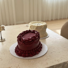 Load image into Gallery viewer, burgundy vintage cake on a travertine table with a soft white background
