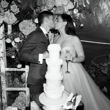 Load image into Gallery viewer, Wedding cake cutting moment during celebration
