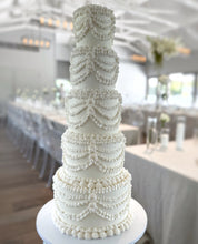 Load image into Gallery viewer, Tall wedding tower cake displayed in a large reception space
