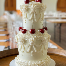 Load image into Gallery viewer, White on white two tier vintage wedding cake with pearl piping and classic buttercream details
