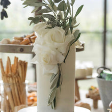 Load image into Gallery viewer, Tall triple stack ethereal cake with smooth white finish and cascading fresh white florals, styled on a dessert table at a wedding reception
